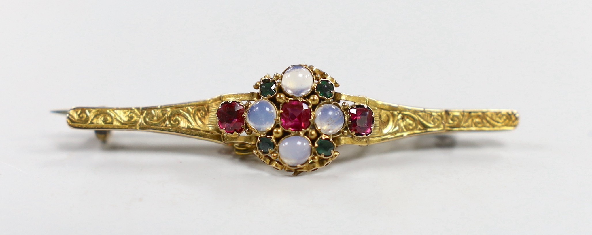 An early 20th century, yellow metal, moonstone, ruby and green garnet cluster set bar brooch, 51mm, with later pin attachment?, gross weight 4.1 grams.